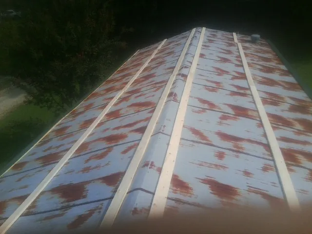 Rusted metal roof panels with new wood purlins before replacement — Storm Damage Roof Repair in Palmerton by Roofing Brothers
