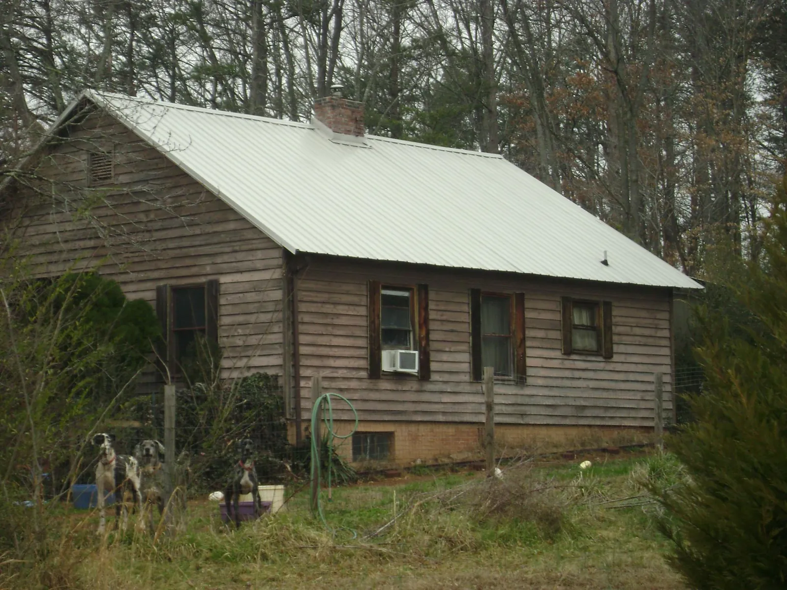 White metal roof on an old wood sided farmhouse, from a Metal Roof Installation job in Palmerton